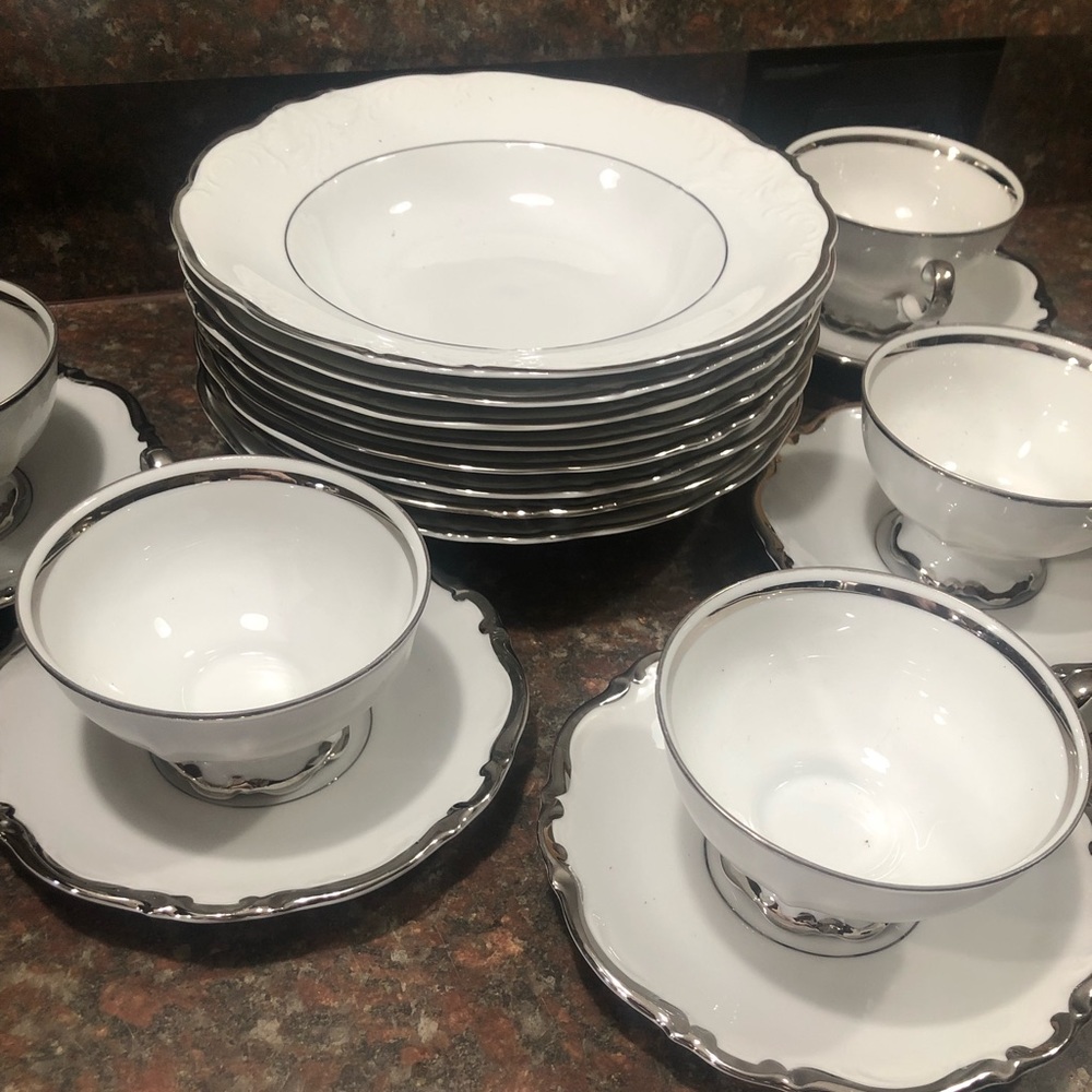 Silver plated china set. 8 deep plates and 5 tea sets